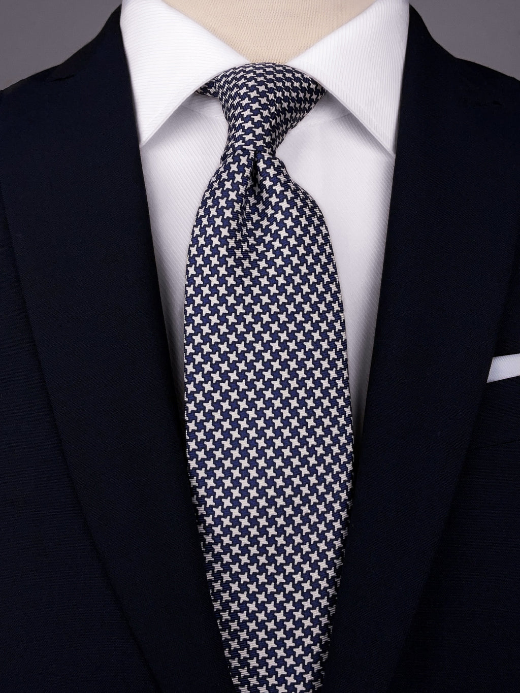 Blue and White Houndstooth silk tie worn with a white shirt and a navy blue suit