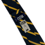 Back side of a Navy blue and yellow striped silk Regimental tie showing the company logo and tag