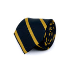 Navy blue and yellow striped silk Regimental tie rolled and placed on a white background