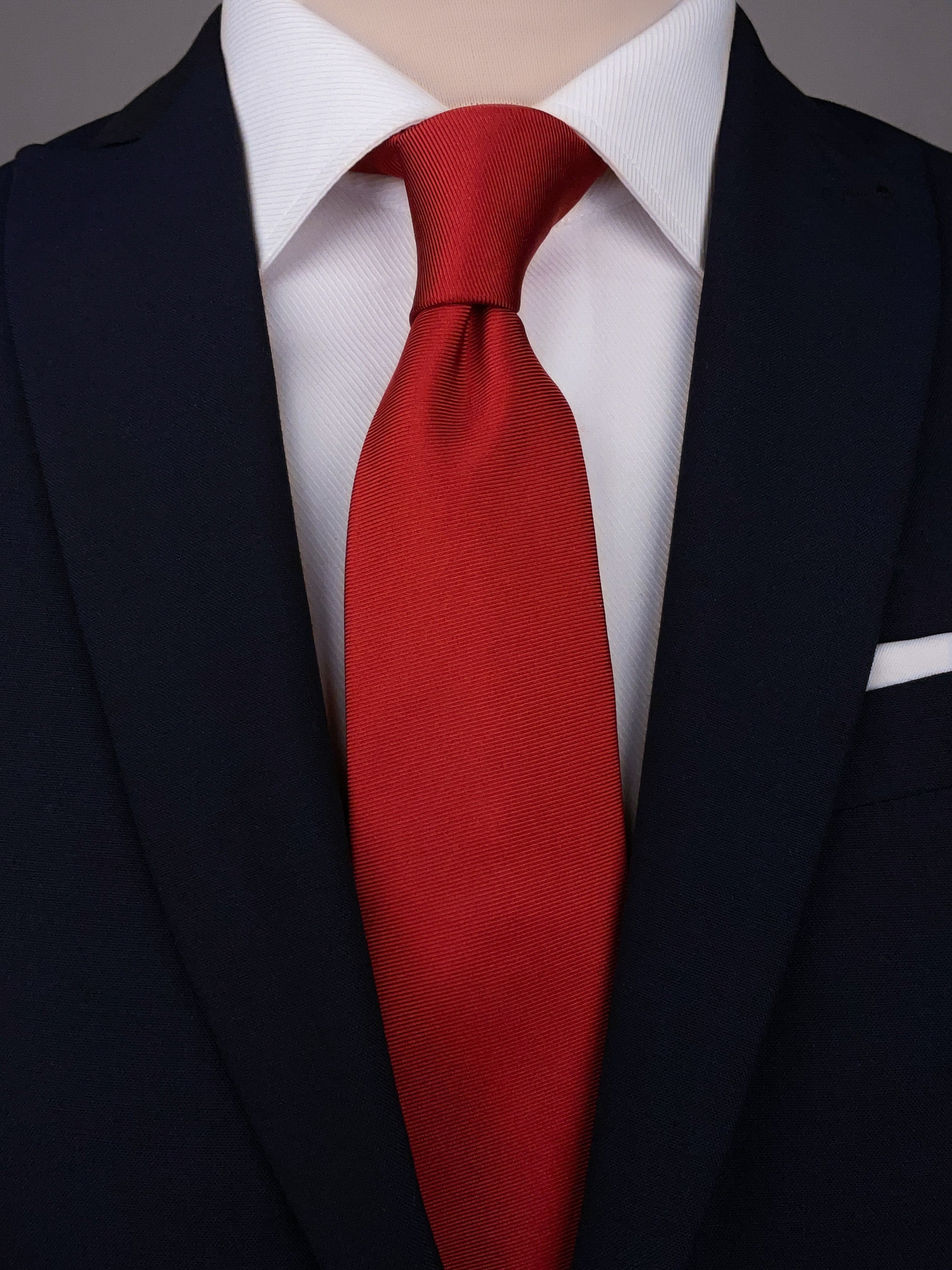 Valentine Red silk necktie worn with a white shirt and a navy blue suit