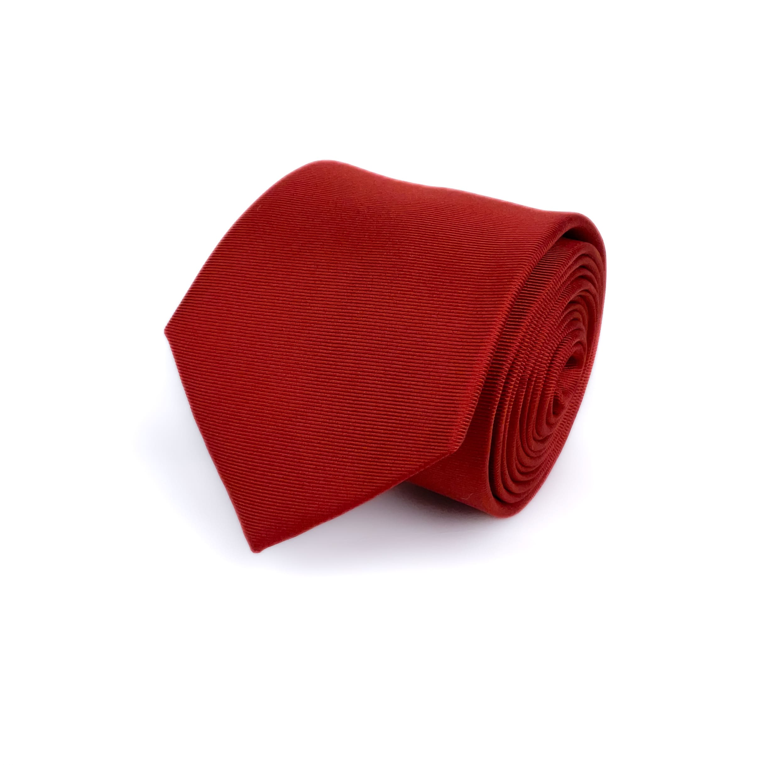 Valentine Red silk necktie rolled and placed on a white background