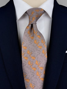 Mulberry silk twill tie in a grey color with a printed pattern of orange fish placed in diagonal stripes worn with a white shirt and navy blue suit