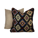 A multicolored bohemian pattern cushion placed on a white background. 