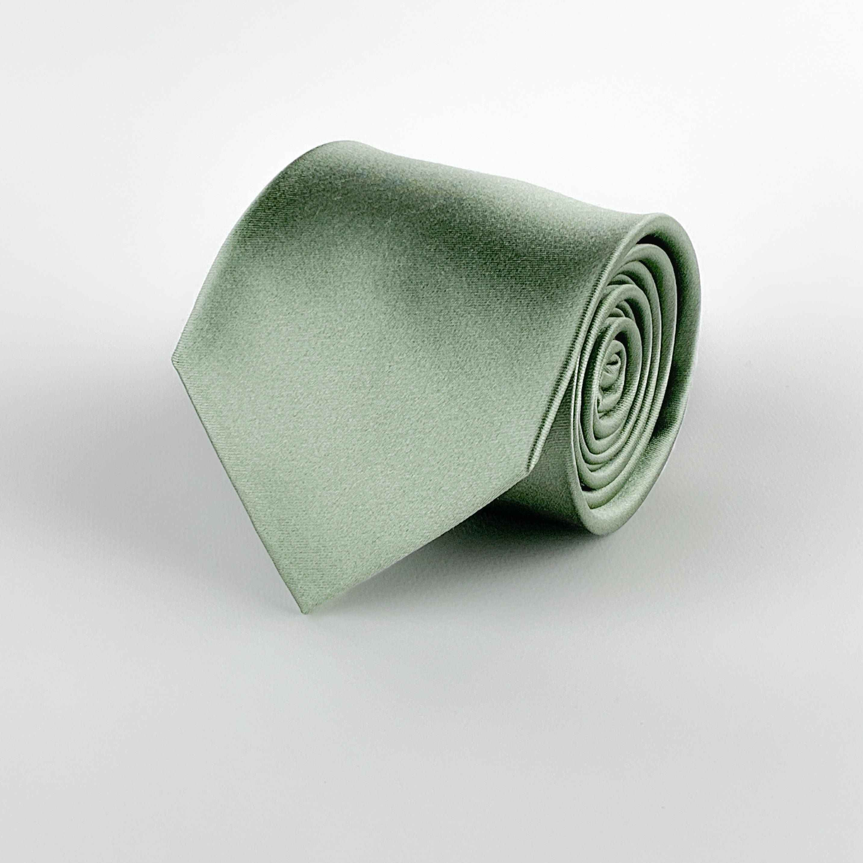 sage green mulberry silk satin tie rolled and placed on a white background
