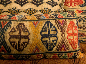 Multiple antique kilim rug cushions placed on a bench