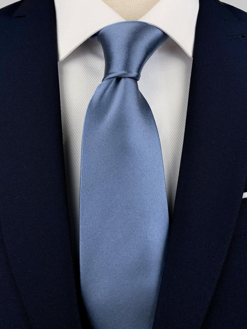 Steel blue mulberry silk satin tie worn with a white shirt and a navy blue suit