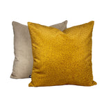A yellow mustard plain suede cushion placed against a white background