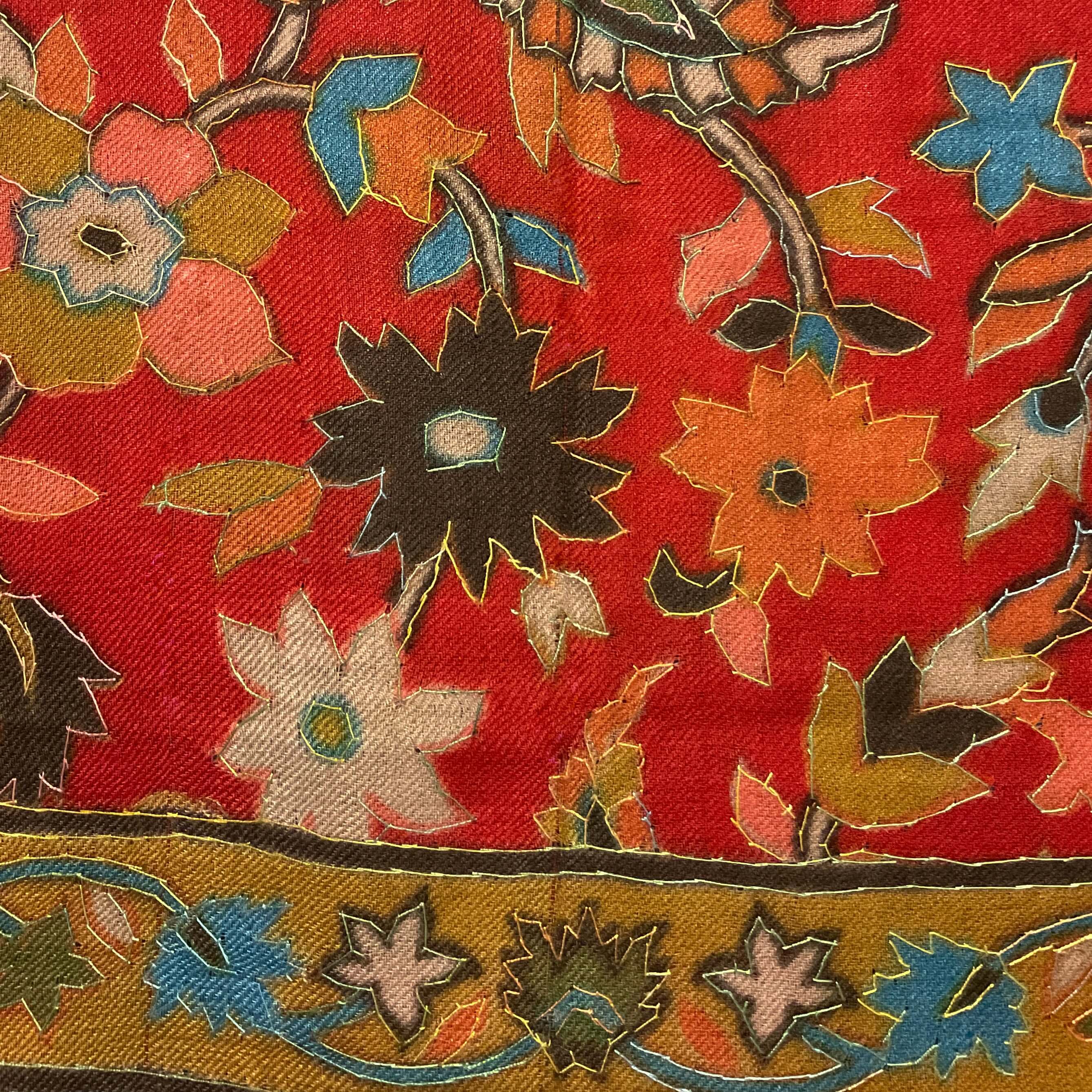 multicolored floral print of a red pashmina-cashmere scarf