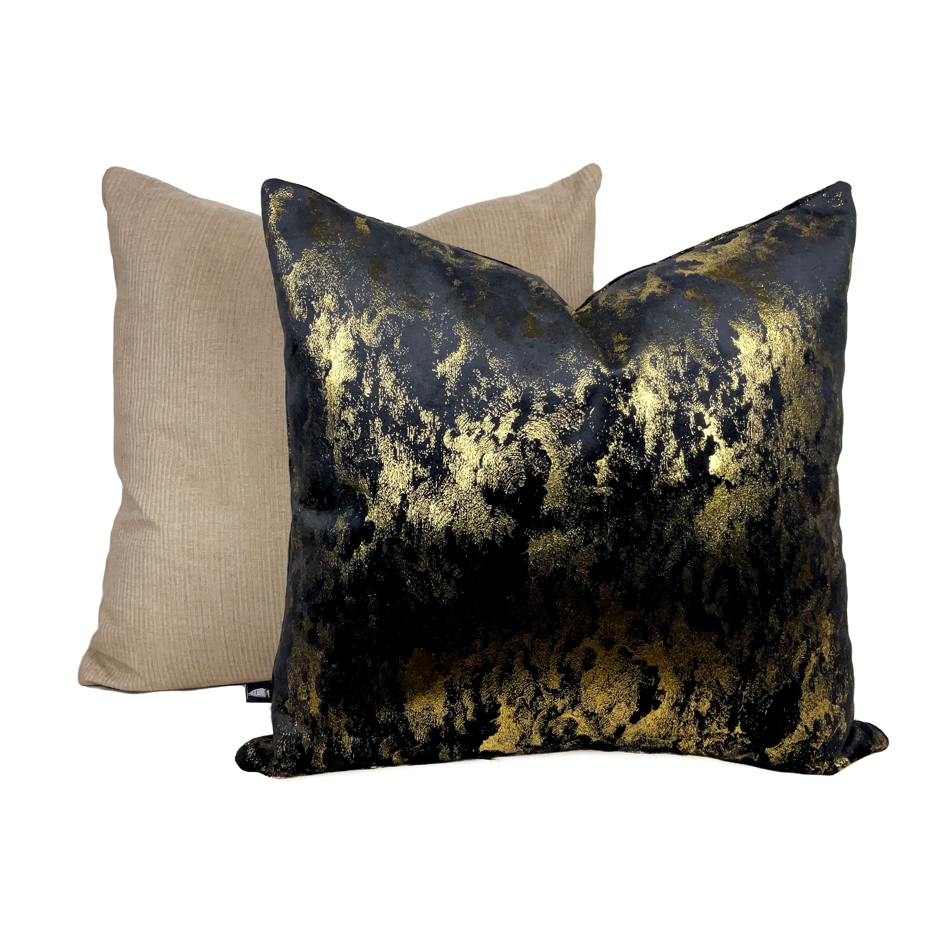 Grey black suede cushion with gold detailing placed against a white background. 