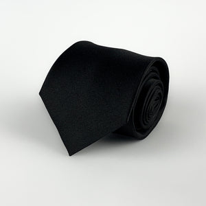Black mulberry silk satin tie rolled and placed on a white background
