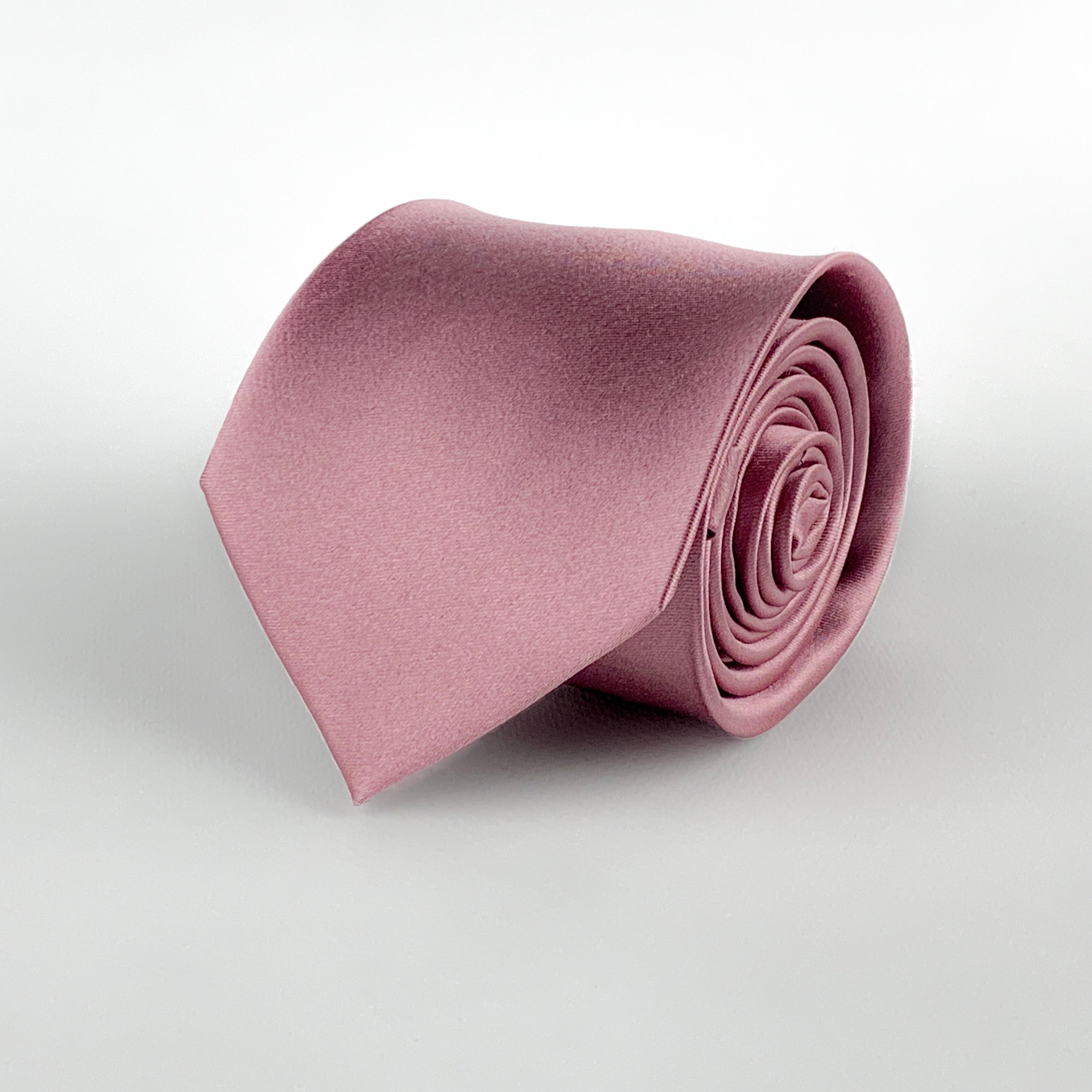 Tea pink mulberry silk satin tie rolled and placed on a white background