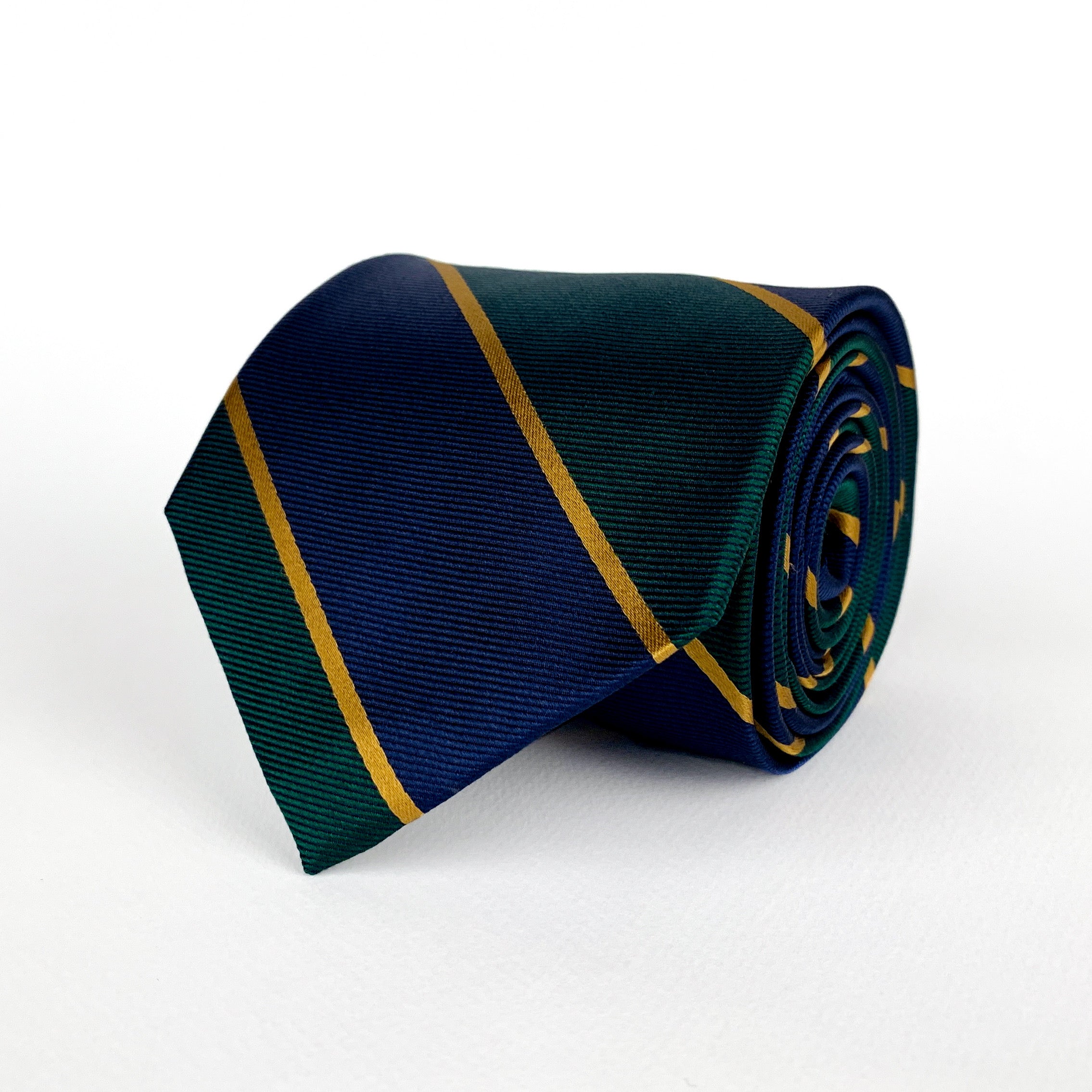 Mulberry silk twill tie with navy blue and dark emerald green regimental stripes and gold woven detailing rolled and placed on a white surface