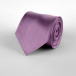 Lilac mulberry silk satin tie rolled and placed on a white background