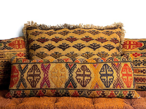 Multiple antique Kilim cushions made from a vintage kilim rug. Cushion has a brown color with multicolored geometric pattern and has a fringe.