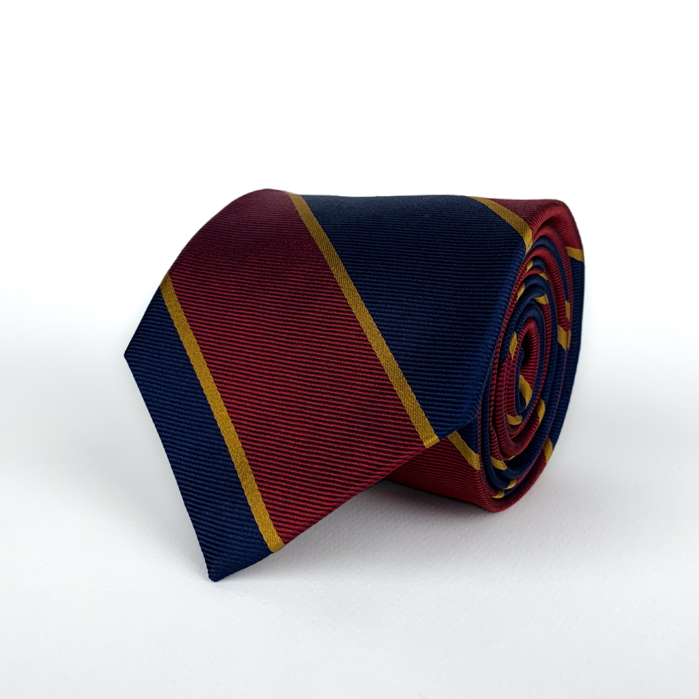 Mulberry silk twill regimental tie with navy blue and red diagonal stripes with woven gold detailing rolled and placed on a white background