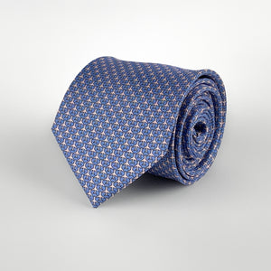 Light blue mulberry silk twill tie with a airplane microprint pattern in a pink shade rolled and placed on a white background