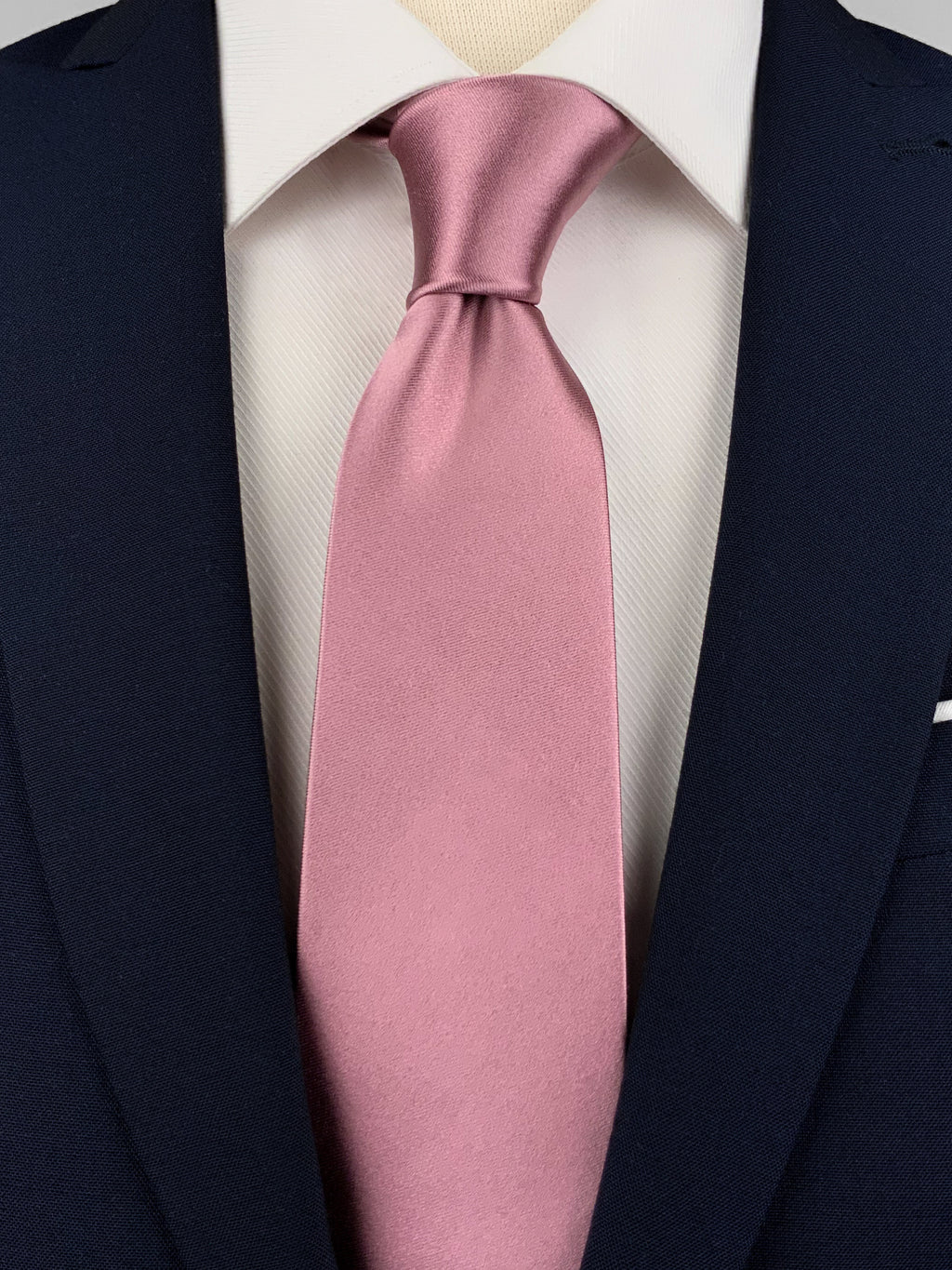 Tea pink mulberry silk satin tie worn with a white shirt and a navy blue suit