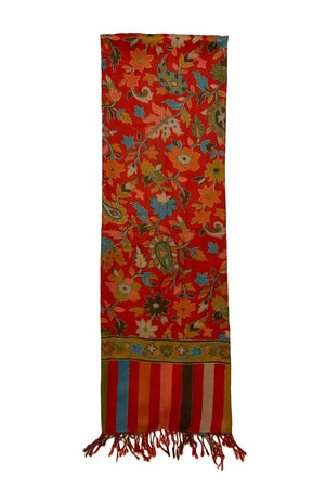 Multicolored floral red pashmina-cashmere scarf folded and placed on a white background