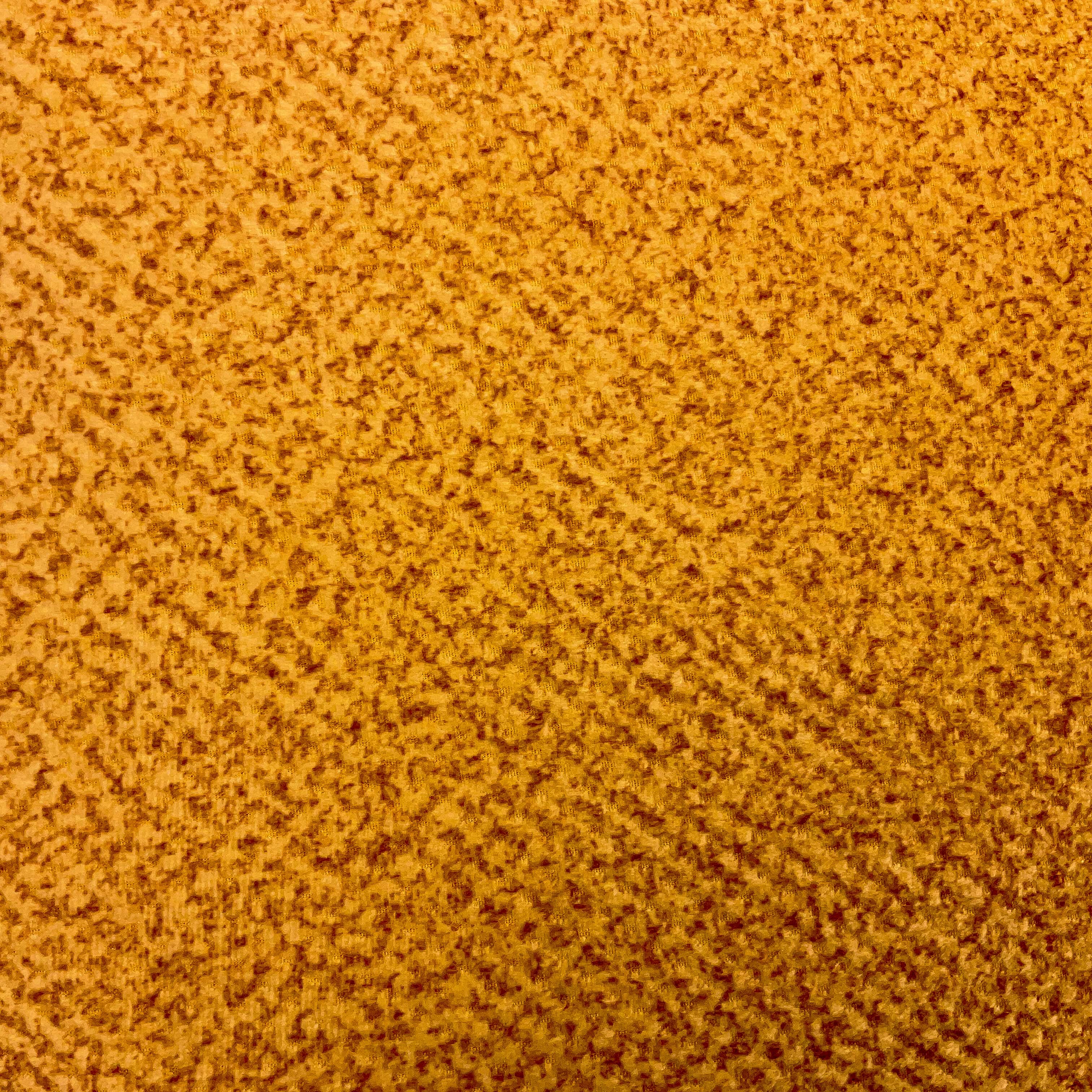 A closeup image of a yellow mustard plain suede cushion showing the inherent pattern