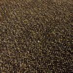 fabric closeup of a plain brown suede cushion showing a geometric pattern