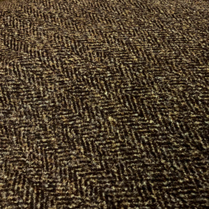 fabric closeup of a plain brown suede cushion showing a geometric pattern