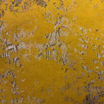 Fabric of a mustard suede cushion with a snake skin pattern printed on it.