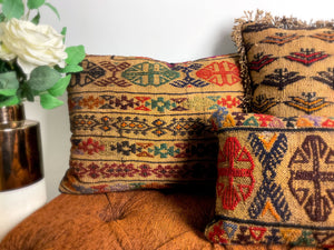 Multiple antique kilim rug cushions placed on a bench