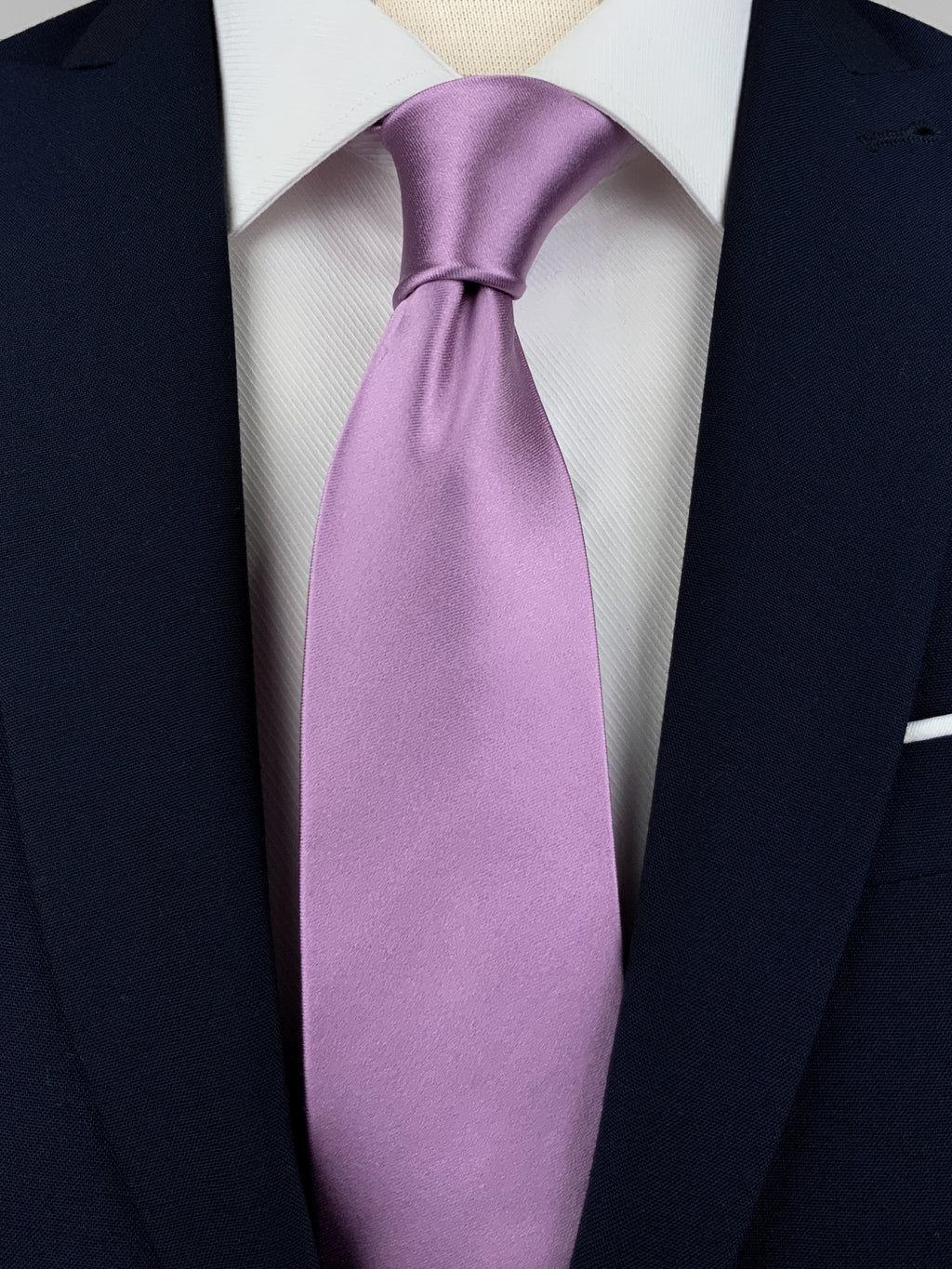 Lilac mulberry silk satin tie worn with a white shirt and a navy blue suit