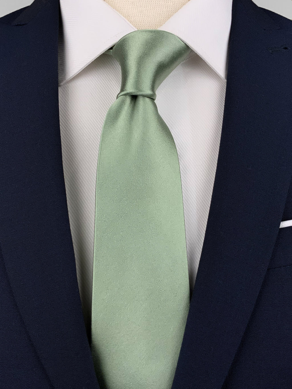 Sage green mulberry silk satin tie worn with a white shirt and a navy blue suit