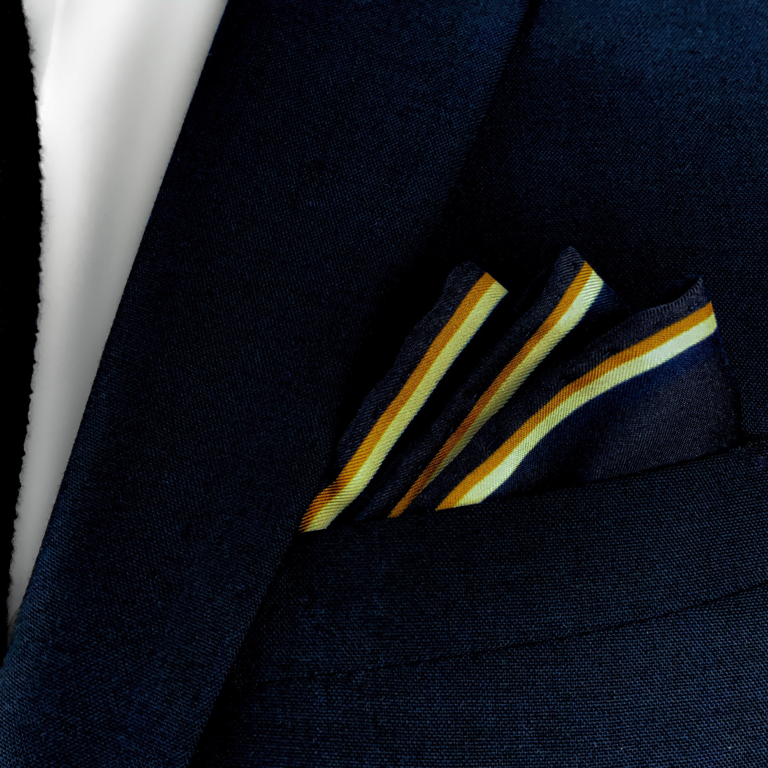 Girl with a pearl earring historical art silk pocket square folded and placed in the breast pocket of a navy blue suit.