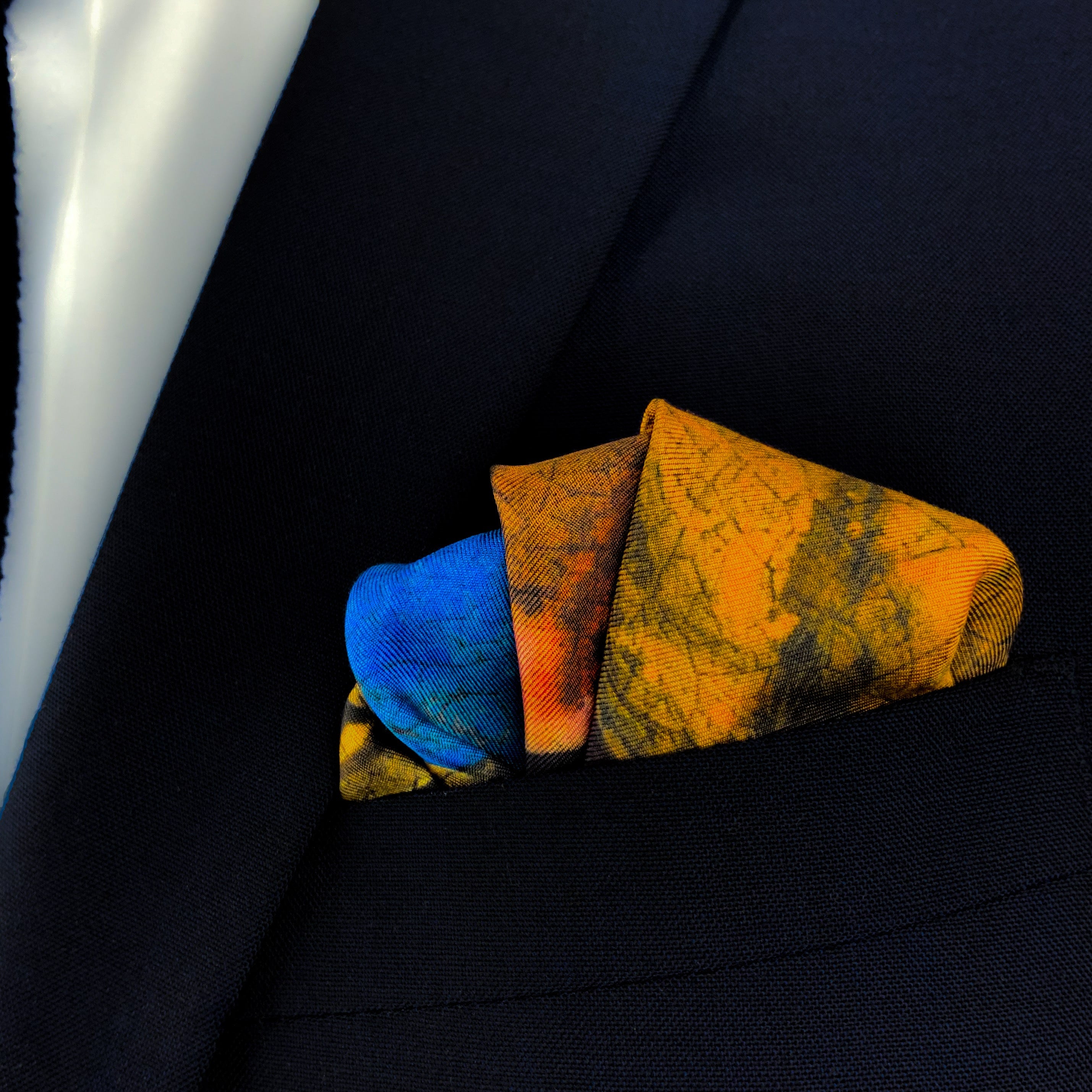 Girl with a pearl earring historical art silk pocket square folded and placed in the breast pocket of a navy blue suit.