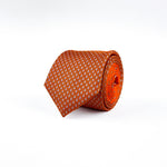 Orange 100% mulberry silk twill necktie with a microprint of airplanes and a bright orange tail rolled and placed on a white background.