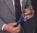 Man holding a historical fine art silk pocket square printed with an image of Vermeer's famous painting called "the girl with the pearl earring".